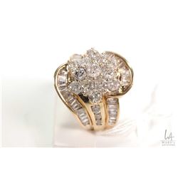 Ladies 10kt yellow gold and diamond cluster ring set with 1.05ct of round full cut diamonds and .70c