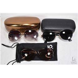 Three pairs of designer sunglasses including Guess, Circus and Donna Karan