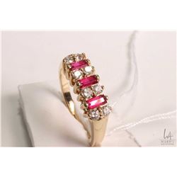 14kt white gold, ruby and diamond ring set with .36cts of baguette cut ruby gemstones and .32cts of 