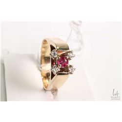 14kt yellow gold ruby and diamond ring set with .15ct round mixed cut ruby gemstone and four 0.25ct 