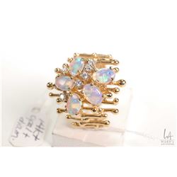 14kt yellow and white gold opal and diamond ring. Set with five .20ct cabachon opal gemstones and .1