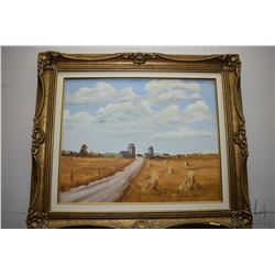 Framed oil on board painting of a wheat stacks and grain elevators signed by artist Robert Harrison,