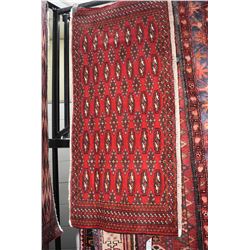 Small 100% wool scatter rug with red background, and highlights of copper, cream and black, 23" X 51