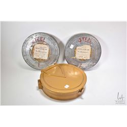 Two vintage film canisters containing "The Making of Steel, Part 1" and "The Making of Steel, Part 2