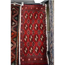 Small 100% handmade scatter rug with red background, black, cream and taupe highlights, 17" X 38"