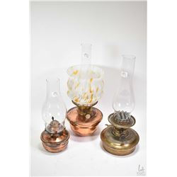 Three vintage metal oil lamps including copper lamp with end of day style glass shade, brass lamp, b