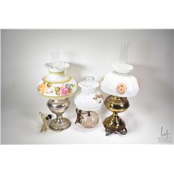 Three electrified oil lamps with shades and hurricanes