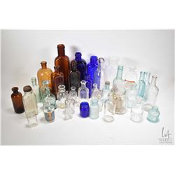 Large selection of vintage bottles including apothecary, cobalt glass, amber glass etc.