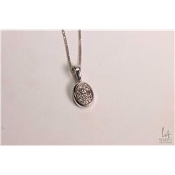 Ladies 14kt white gold 18" in length with a 14kt white gold and diamond pendant