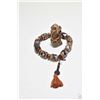 Image 1 : Sino-Tibetan Dzi bead prayer bracelet and a small archastic stone figure