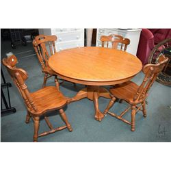 Semi contemporary 48" diameter center pedestal oak dining table with carved paw feet plus a set of f