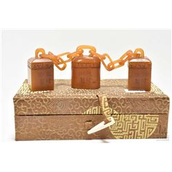 Boxed set of three chained yellow soap stone seal, purportedly 20th century, note fragile item