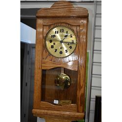 Hand crafted oak cased chiming wall clock with visible pendulum, note working at time of cataloguing