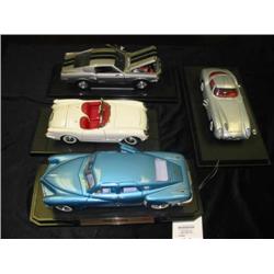 grouping of 4 diecast model cars 1/1:18