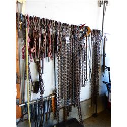 CHAINS, BOOMERS, WIRE, HOSE, STRAPS, ETC HANGING ON WALL