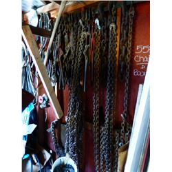 ASSORTED CHAINS & BOOMERS ON BACK WALL OF SHED