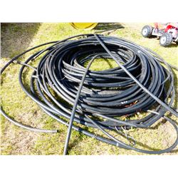 PILE OF BLACK PLASTIC HOSE