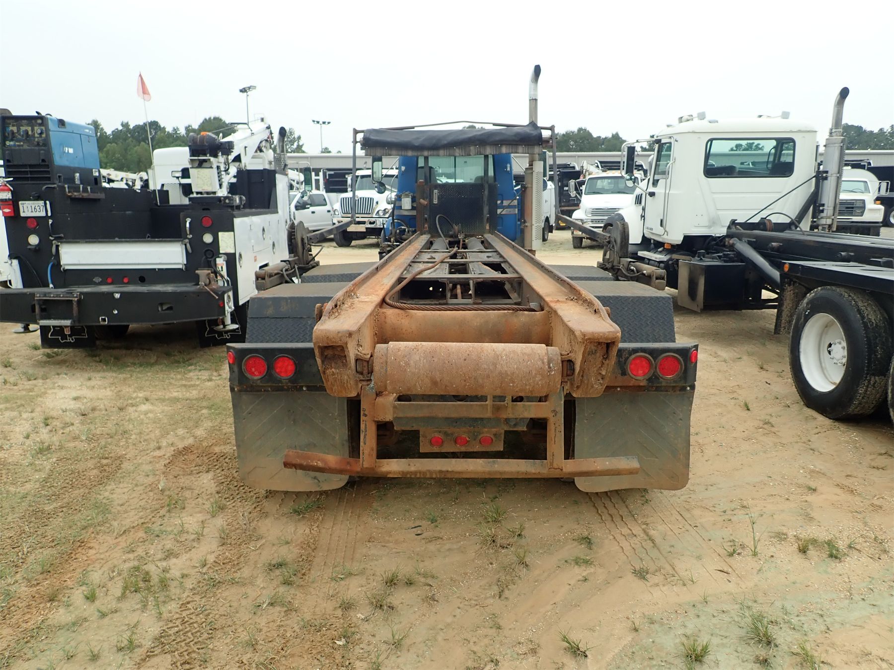 2000 MACK RD690S Roll Off Truck J.M. Wood Auction Company, Inc. 2000 MACK RD690S Roll Off Truck J.M. Wood Auction Company, Inc.