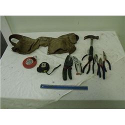 leather pouch, hammer, tape measures, pliers, snips, etc