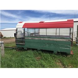 Covered sleigh green in color with tin and plexi  glass sides and roof, bench seats