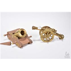 Two miniature cannons including 6 1/4  wooden cart with big bore cannon and a brass connon on a bras