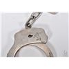 Image 2 : Pair of vintage genuine Colt Firearms handcuffs, serial no. 008194 with two keys and a Colt keychain