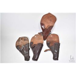 Four Tokarev leather handgun holsters with mag storage and two include cleaning rods.