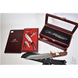 Three collectible knives including Winchester wooden handled hunting knife with 9" blade and canvas