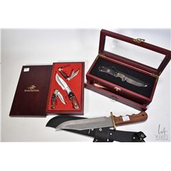 Three collectible knives including Winchester wooden handled hunting knife with 9" blade and canvas 