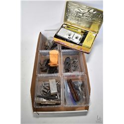 Tray of miscellaneous rifle parts and scope rings.