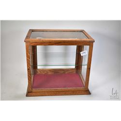 Small antique showcase/retail display cabinet with glazed front, sides and top and single glazed doo