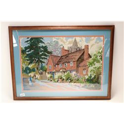 Framed needlework of an English cottage purportedly stitched by a woman wholived on that street, ove