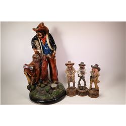 Ceramic cowboy figure, 21  in height and three small resin cowboys approximately 10  in height.