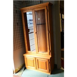 Large oak and glass locking four door gun display with lowered storage and two glazed door, set up f