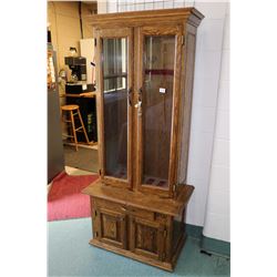 Large oak and glass locking four door gun display with lowered storage and two glazed door, set up f
