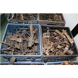 Two crates containing a selection of vintage leg hold traps, approximately 40 count.