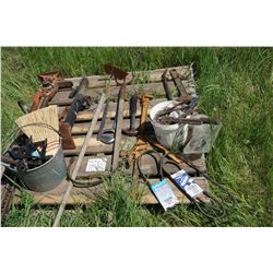 Jackall, pail of guards, implement jack, garden hoe, pitch fork, hacksaw, wire stretcher, assortment