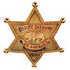 Howard Hughes personal Los Angeles County Deputy Sheriff badge presented by William I. Traeger.