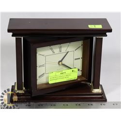 QUARTZ CLOCK IN A SWIVEL MAHOGANY STAND WITH