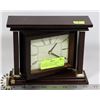 Image 1 : QUARTZ CLOCK IN A SWIVEL MAHOGANY STAND WITH