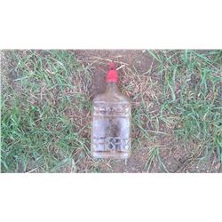 GLASS BOTTLE CONTAINING OIL