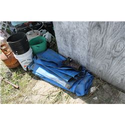 PILE OF BLUE TARPS