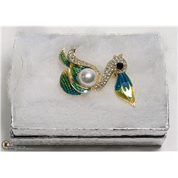 ENAMELED WITH RHINESTONES PELICAN BROOCH AND A