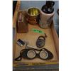 Image 1 : Box with:  Bell; Lock; Goggles; Lighter; Mud Jug; Tobacco Tin