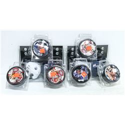 ASSORTED LICENSED HOCKEY PUCKS AND MINI HELMETS