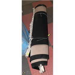 LARGE BLACK AND TAN AREA RUG.