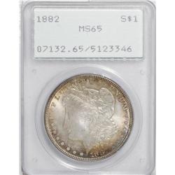 1882 S$1 MS65 PCGS. Lovely orange-gold, plum, steel-gr 