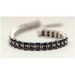 94) A STERLING SILVER SAPPHIRE BRACELET.
