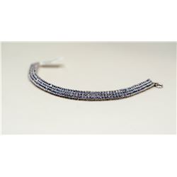 98) A STERLING SILVER TANZANITE BRACELET.