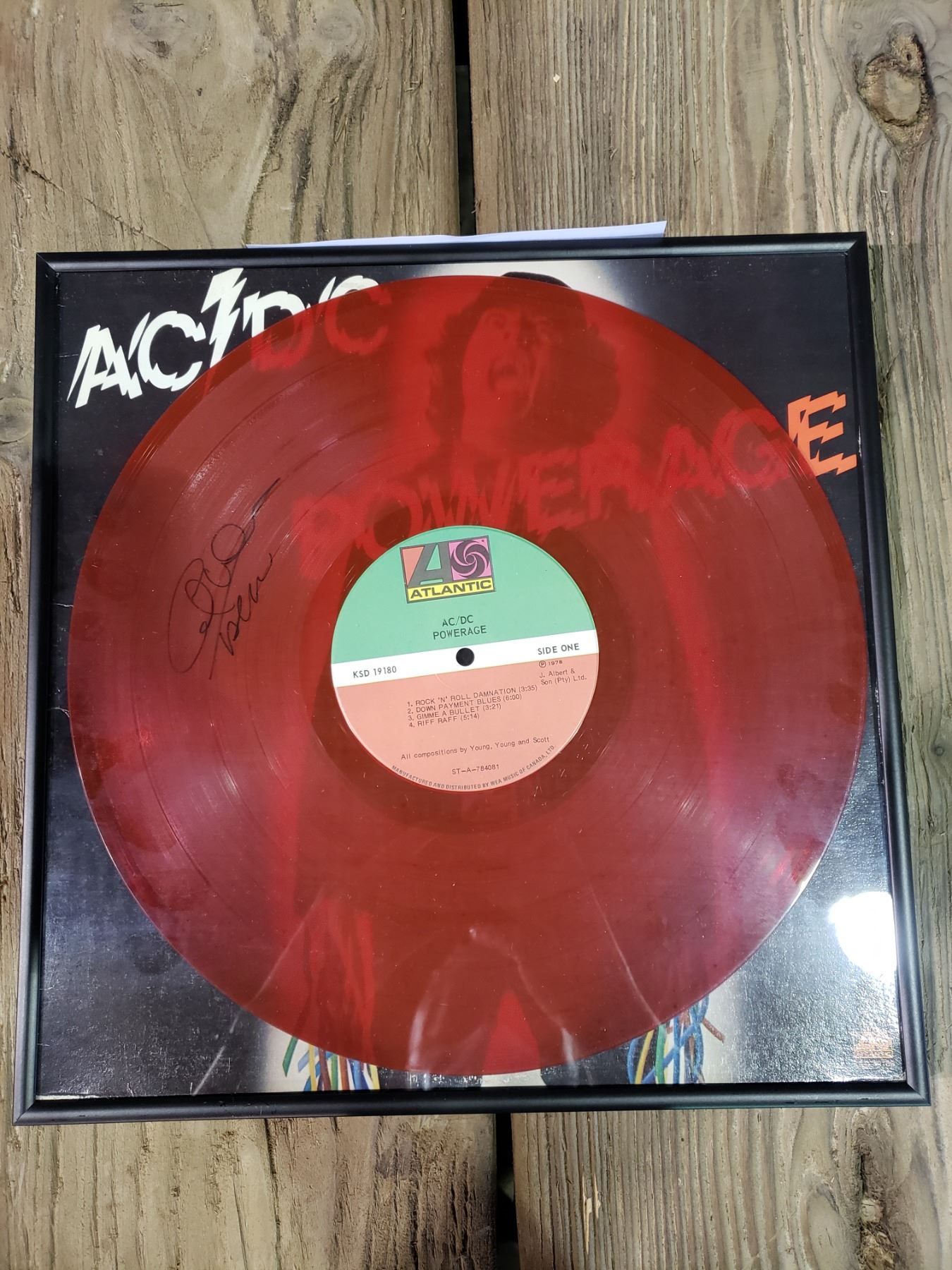 AC/DC SIGNED AND FRAMED POWERAGE RED TRANSLUCENT LP, SIGNED BY ANGUS YOUNG.